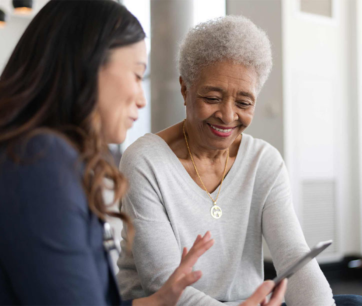Smiling patient with doctor looking at phone