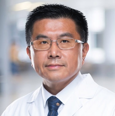 Dr. Zheng in a white coat
